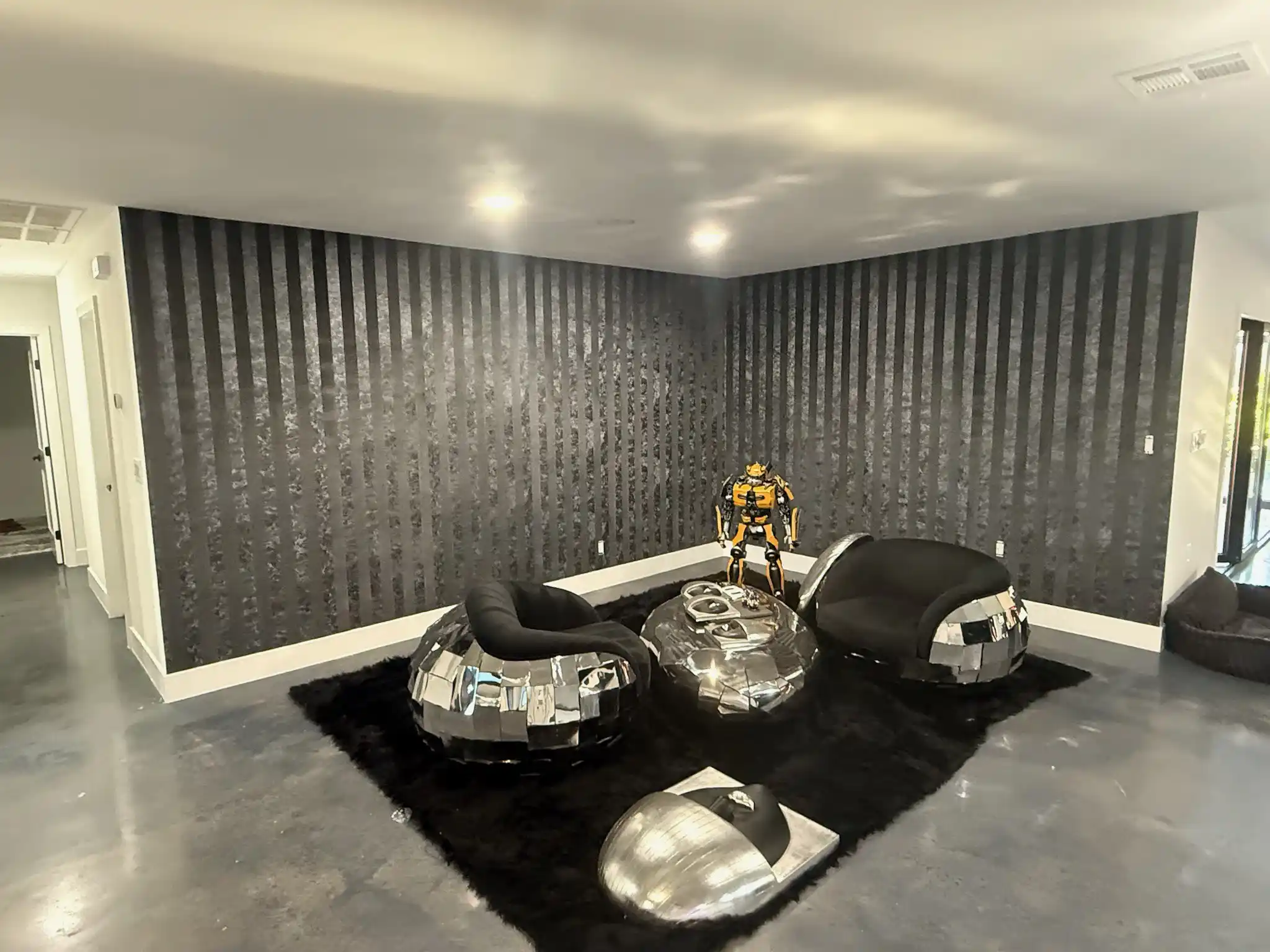A dining area framed by a dark textured wallcovering